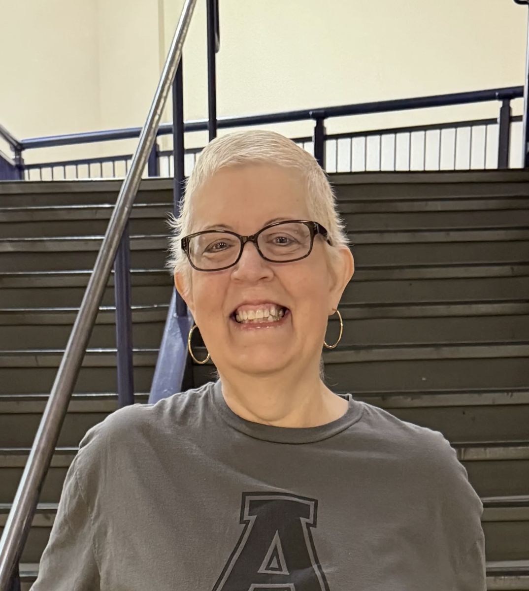 Image is of the ECHS counselor. She is smiling, and is wearing a grey shirt with a large A.
