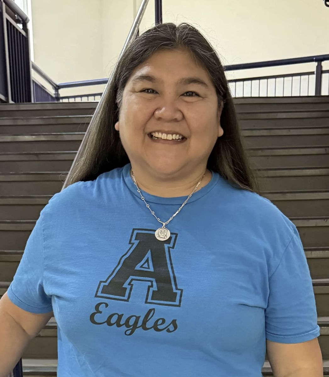 Image is of the Green Tech counselor. She is brunette and smiling, and is wearing a blue shirt with a large A and eagles written below it.
