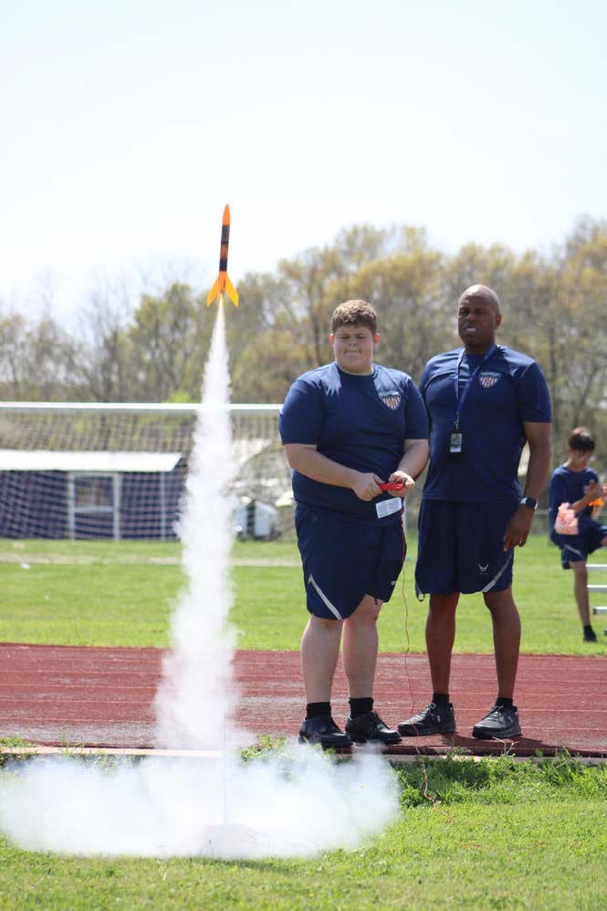 student controlling a rocket take off